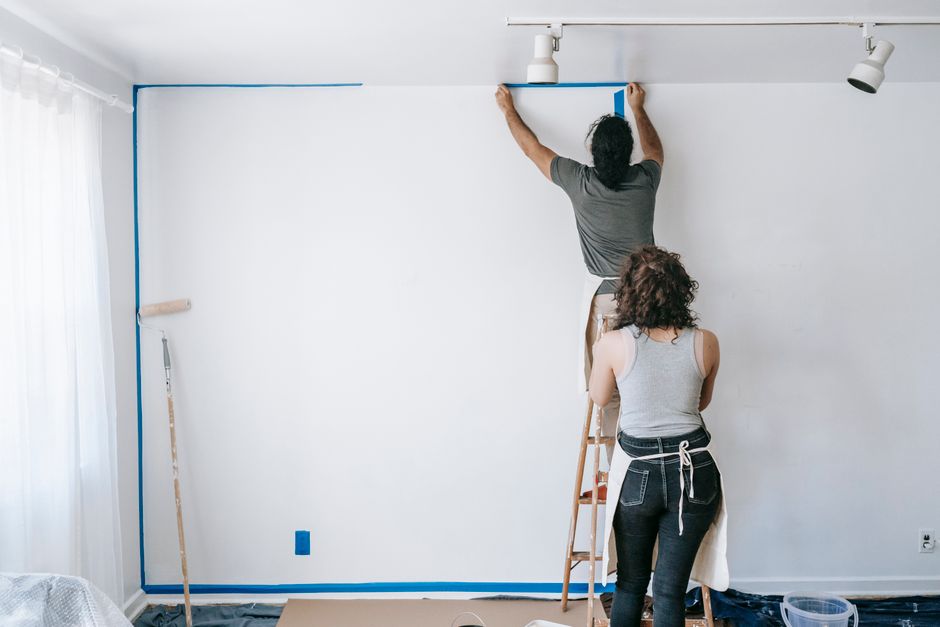 Professional home renovation team discussing window installation plans